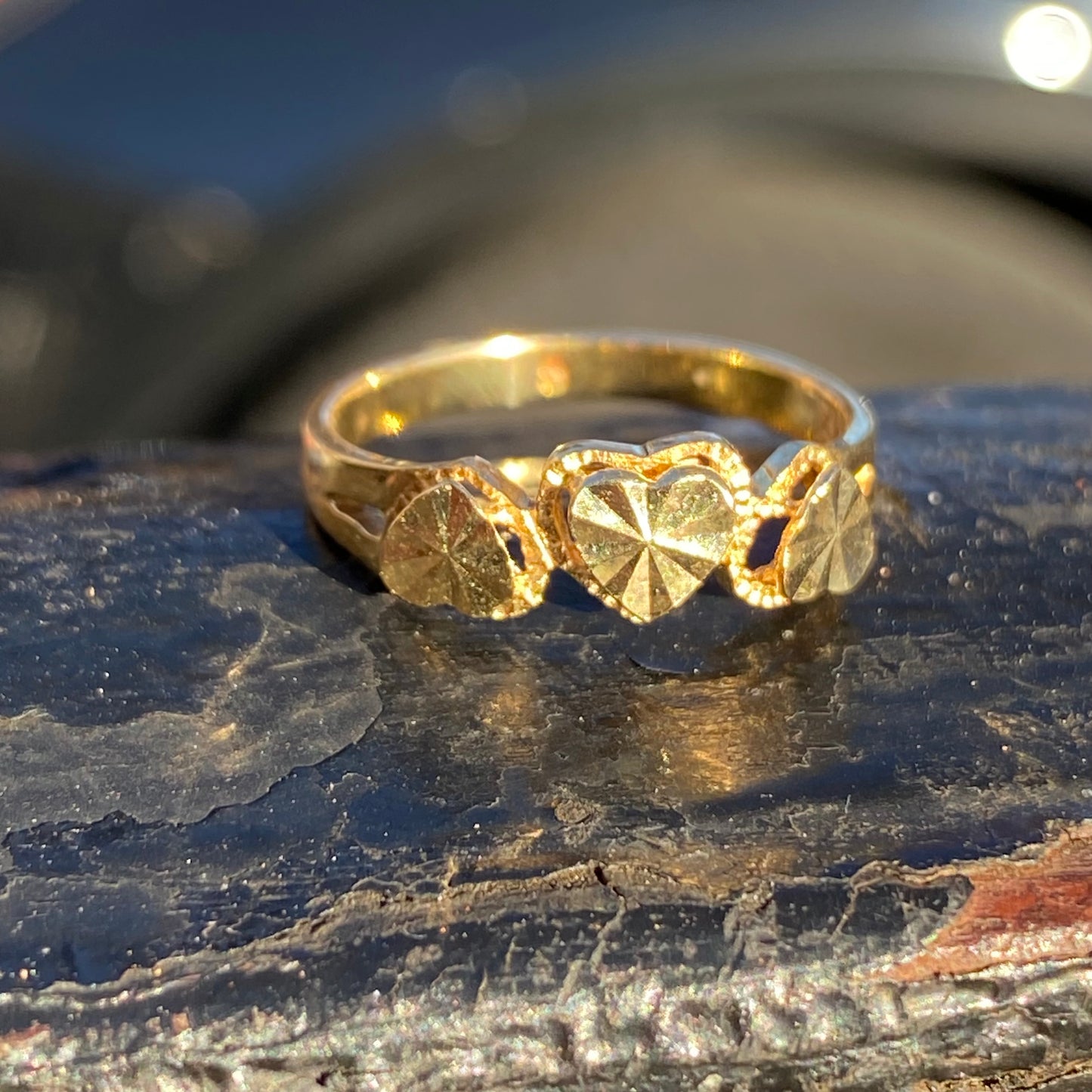 Engined-turned three heart ring