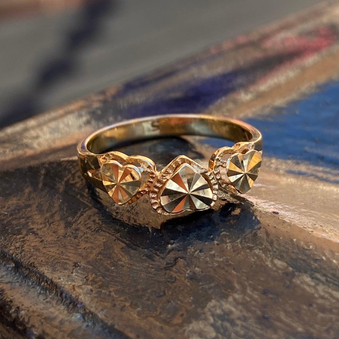 Engined-turned three heart ring