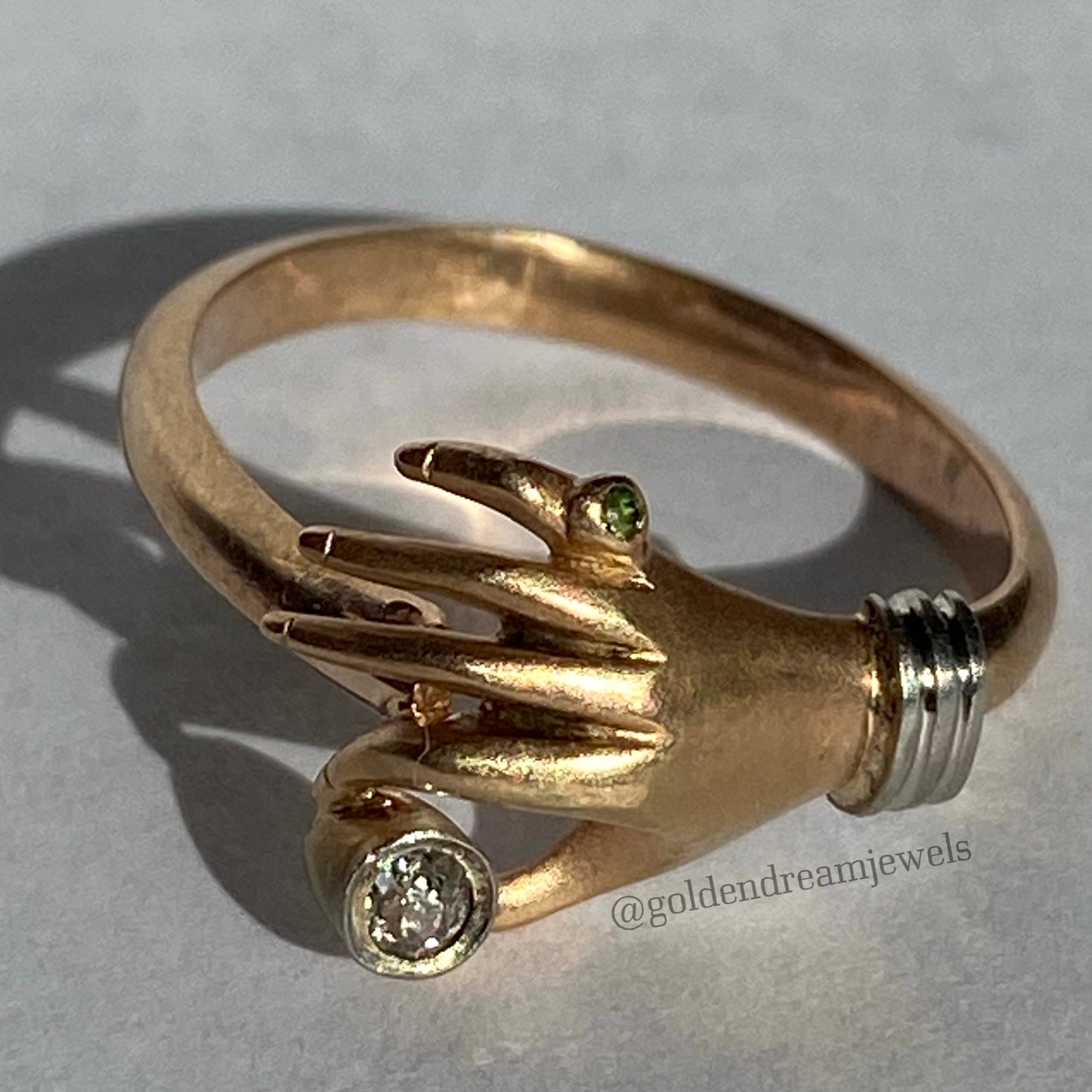 Vintage hand ring holding a diamond