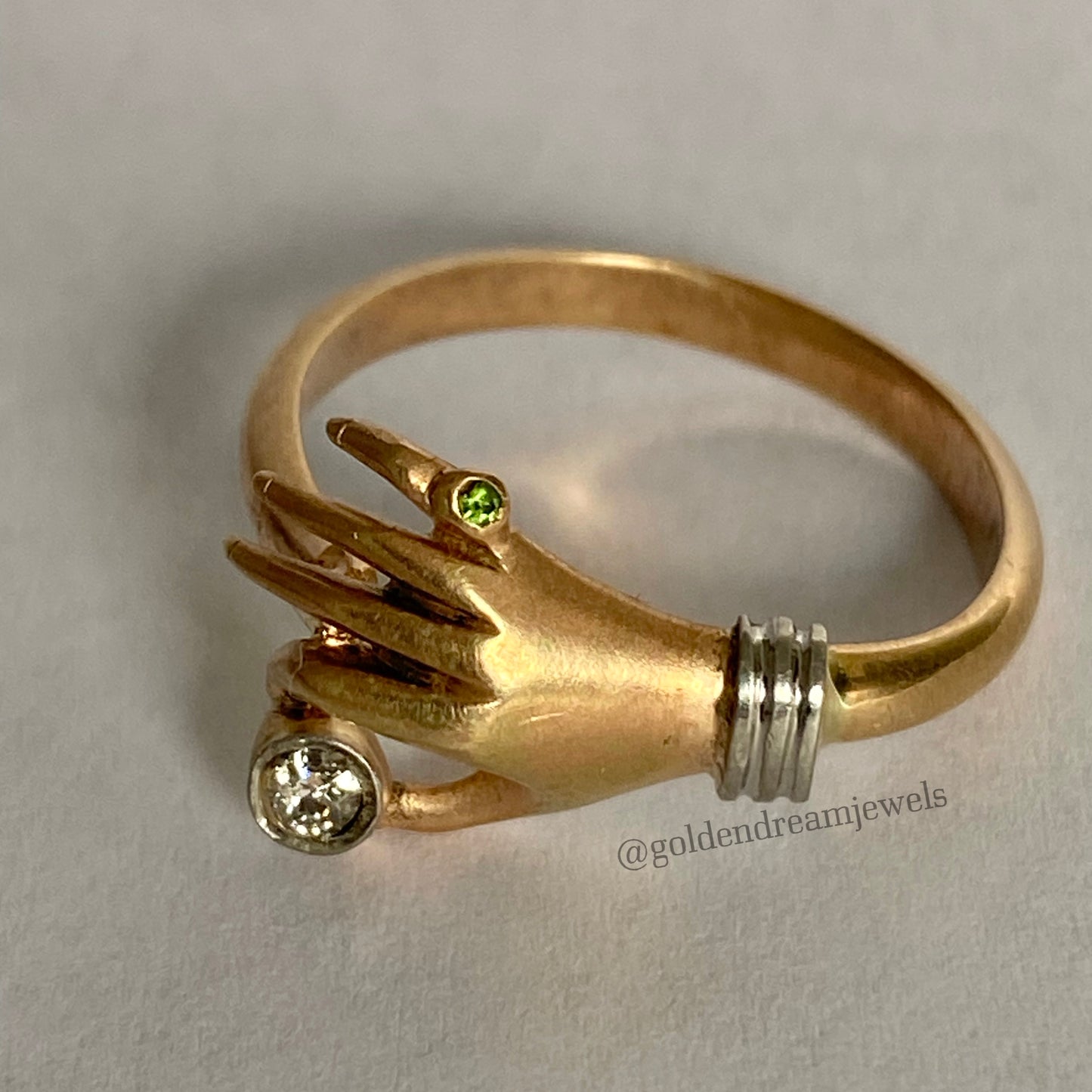 Vintage hand ring holding a diamond